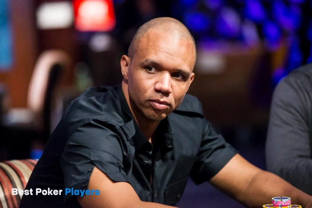 Phil Ivey playing poker at table with chips in front and serious expression
